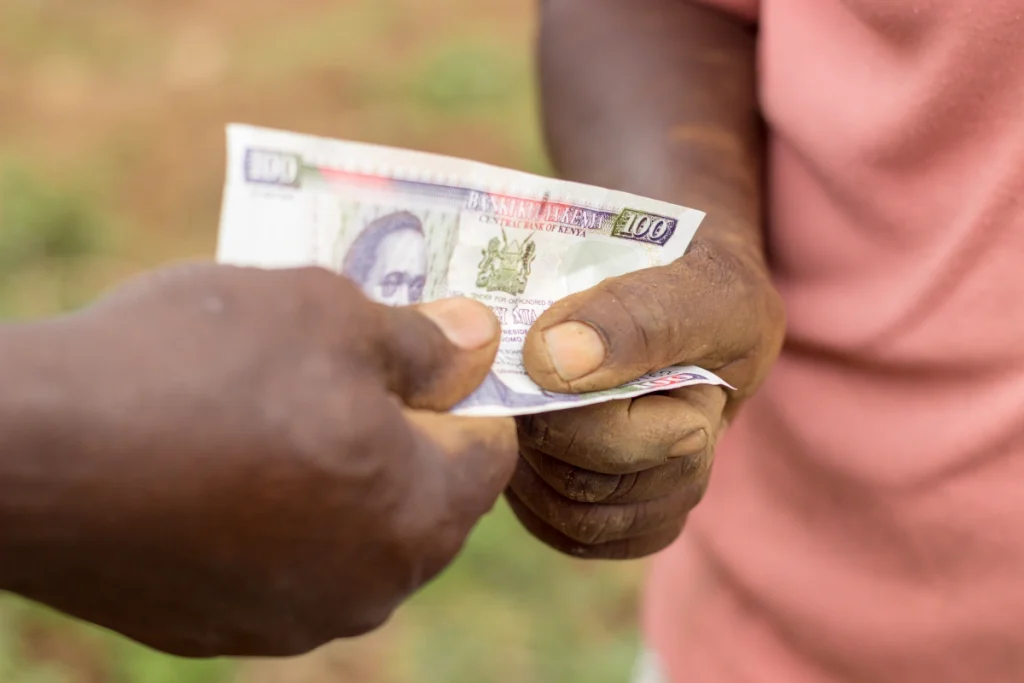 Two People Exchanging Kenya Currency